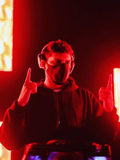 A masked performance piece, where the visuals on the screen behind me add to the mystery and theatricality of the set.