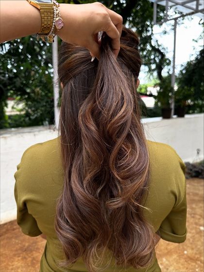 Getting her 'Vacay Hair' on with these beautiful ribbon highlights. This technique creates a gorgeous, flowing look that’s perfect for showing off on your next trip.