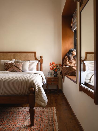 A serene moment captured in a bedroom at Mount Pleasant, where a deep-set window provides a tranquil connection to the misty landscape outside.