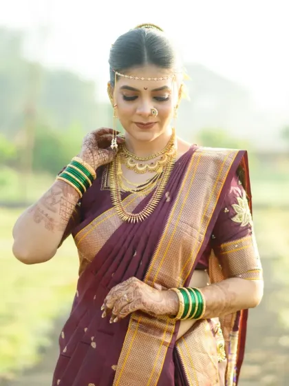 The bride adjusting her jewellery, a classic pose that highlights the intricate details of her look.