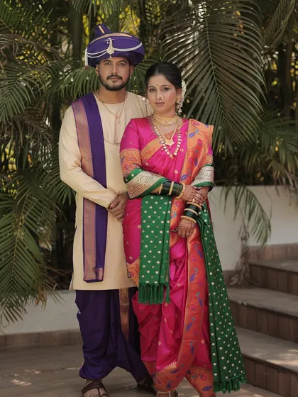 A full-length portrait of the couple, showcasing their coordinated and regal outfits.