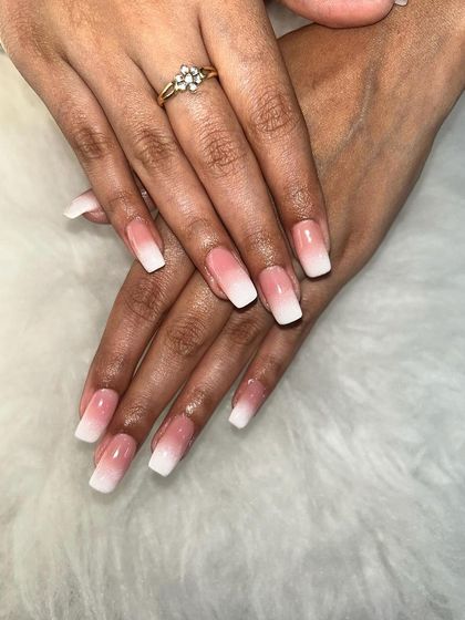 A classic pink and white ombre on long, square-shaped nail extensions. This is a popular choice for a feminine and clean look.