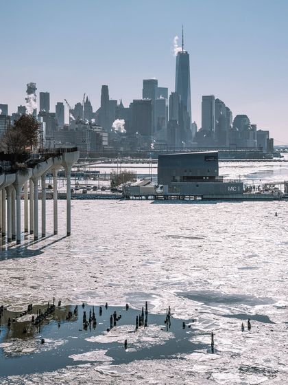 A wider view of the frozen Hudson River, with the downtown skyline in the background. This shot captures the scale of a New York winter.