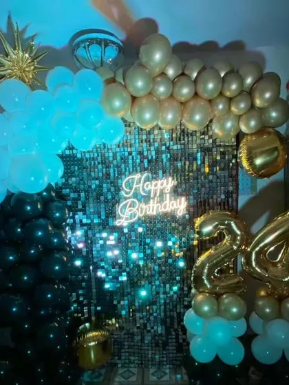 The same shimmer wall setup seen with blue uplighting, which completely changes the mood and makes the sequins sparkle differently. We can customize the lighting to fit your party's theme.