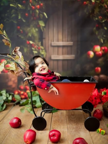 Apple of my eye. This charming apple orchard theme, with a red wagon and plenty of apples, creates a sweet and colorful backdrop.
