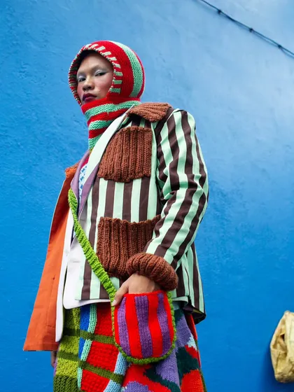 A close-up on the details from the "Kaleidoscope" series. The intricate textures of the knitwear and the bold color palette are the focus here, showcasing the artistry of the garments in this avant-garde fashion shoot.