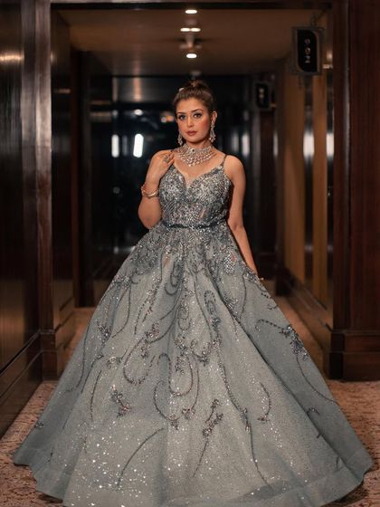 A full-length shot of the mint organza gown. The intricate, swirling patterns of sequins and crystals cover the entire dress, making it a true work of art.