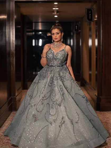 Our mint shimmer organza gown is a vision of elegance. The flared silhouette is encrusted with sparkling sequins and crystals, creating a look that is both sophisticated and breathtakingly beautiful.