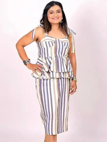 A full-length shot showing the complete look, proving that professionals can also rock a glamorous photoshoot.