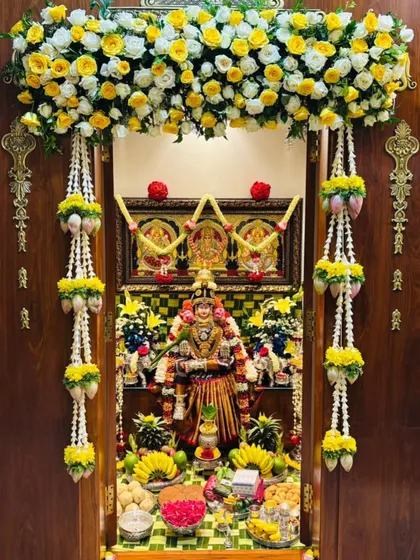 You will learn the art of decorating sacred spaces, like this beautiful pooja room for Varamahalakshmi. We cover everything from floral arrangements and fruit displays to traditional lotus and thomale garlands.