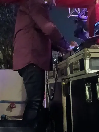 A candid shot of me on the decks during a baraat. Even in a mobile setup, I'm focused on delivering a seamless and high-energy musical experience for the wedding procession.