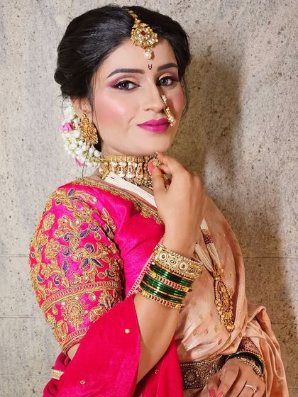 A side profile of a Maharashtrian bride, showcasing the intricate hairstyle and the beautiful details of her jewelry and saree.