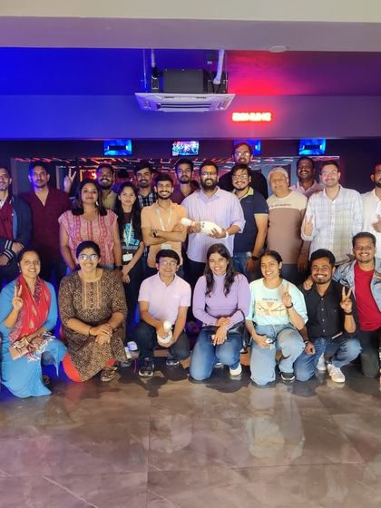 A large group from a corporate outing posing for a picture. Our spacious venue is ideal for big company events.