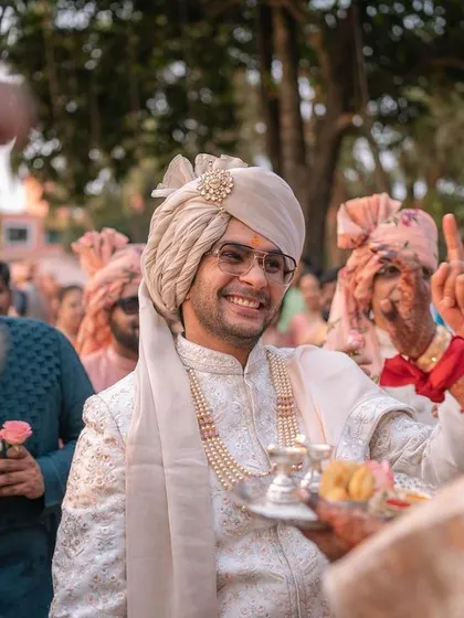 The groom's happy face as he is welcomed by family at the start of his wedding ceremony.