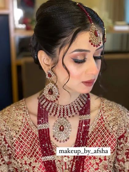 The full look, with the jewellery and makeup perfectly complementing her red and gold outfit.