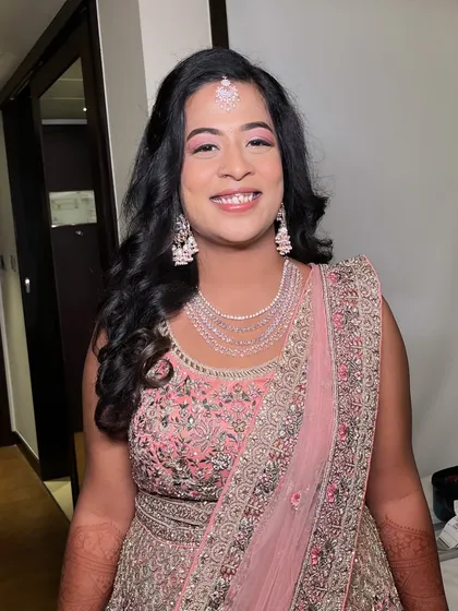 A final look at Ritu's engagement makeup. The soft curls and glowing skin create a timeless and elegant style that is perfect for any pre-wedding celebration.