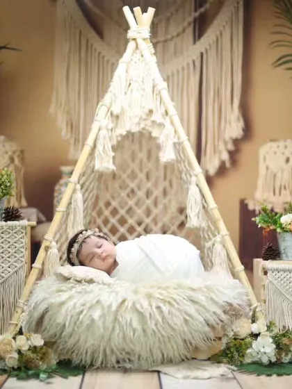 This dreamy boho-chic setup features a miniature macrame teepee, soft furs, and natural textures. It’s one of our most requested styles for parents looking for an earthy and artistic newborn session.