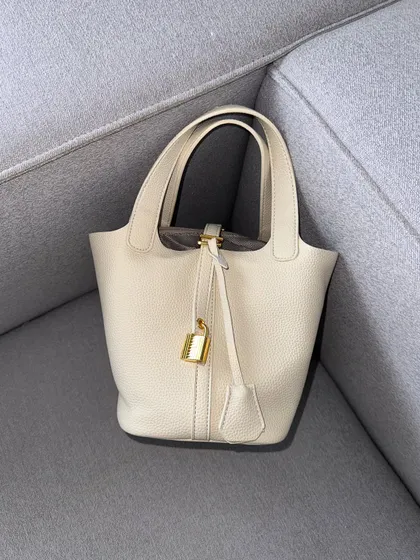 The HerCharm Bucket Bag in a beautiful off-white colour. This is a perfect neutral shade that will match almost anything in your wardrobe.