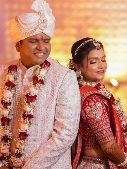 A playful and happy shot of the bride and groom. Her makeup is designed to last through all the smiles and laughter of the day.