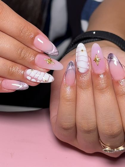 A playful and textured set combining lilac and white nails with 3D knitted patterns and gold star charms.