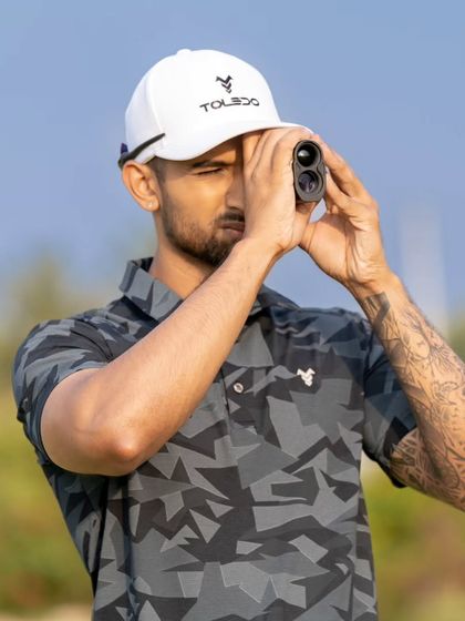 Course management is a critical mental skill. Here, a player uses a rangefinder to get an exact distance, a key part of the strategic approach we teach.