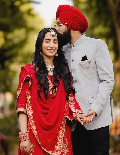 A moment of pure bliss. The groom's gentle kiss on his bride's forehead is a classic expression of love that we love to capture.