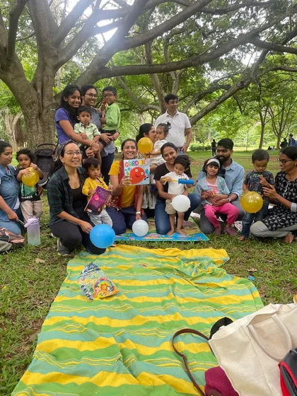 A big group photo from our 'Friendship' themed day, with kids and parents holding balloons. This picture is bursting with the joy and camaraderie of our community.