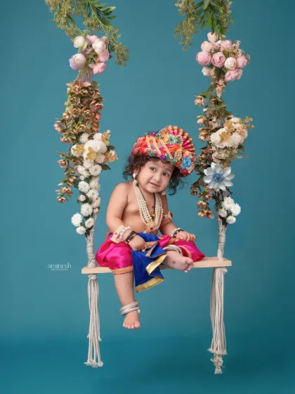 Another charming pose on the floral swing, this little Krishna looks inquisitively at the camera. My studio is equipped with a variety of props like this to create diverse shots within a single theme.