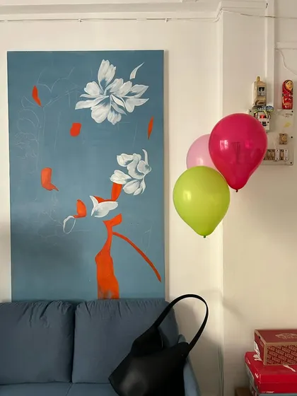 A quiet corner of my studio, where a finished painting lives for a while before going to its new home. The balloons add a touch of accidental celebration.