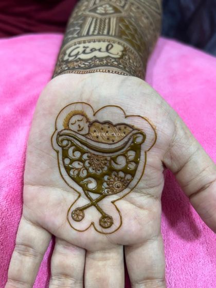 A minimalist and incredibly sweet baby shower design, with just a simple, detailed drawing of a baby sleeping in a floral cradle on the palm.