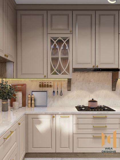 A close-up of the hob area, showing the elegant cabinet details and brass handles.