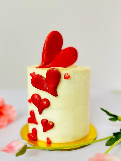 A close-up of the Valentine's Day mini cake with cascading red hearts, showing the detail and care I put into each handcrafted decoration.