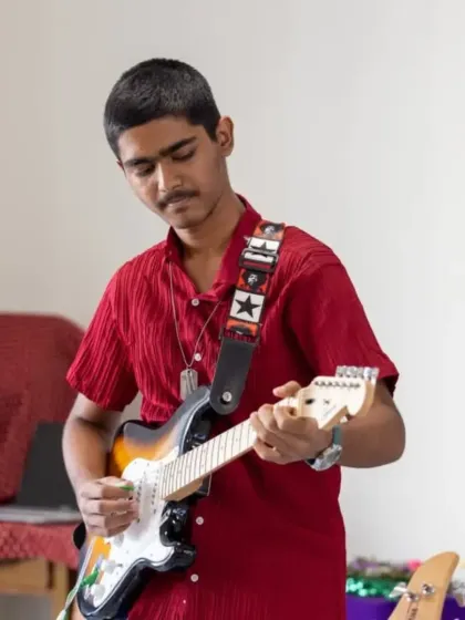 One of our talented guitar students plays a solo during a performance at the home for the aged. Our band coaching ensures every member of the ensemble gets a chance to be in the spotlight.