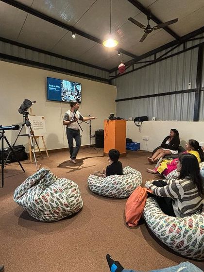 An attendee learns about different types of telescopes during our 'Telescope Exploration' workshop. I love hosting events that spark curiosity and learning.