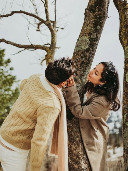 An intimate, romantic moment by a tree during a post-wedding shoot.
