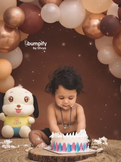 Let's get messy! A first birthday cake smash is all about capturing pure, unfiltered joy. This little one is having the time of his life with his first taste of cake in our cozy, earth toned studio setup.