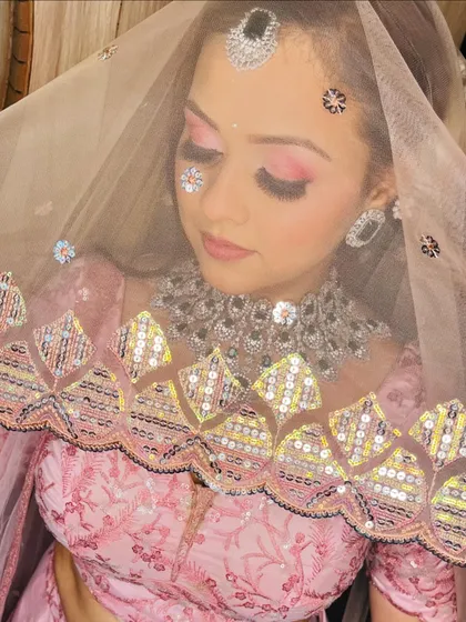 A creative shot with sequins on the face, adding a touch of modern artistry to the bridal look.