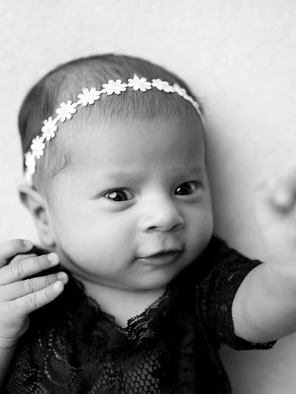 "Hang loose!" This black and white shot captures a baby girl with so much personality in her expression and hand gesture.