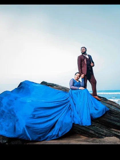 This royal blue gown’s expansive train is spread across the rocks, contrasting beautifully with the sea. It’s a perfect example of how my gowns can transform a natural landscape into a dramatic scene.