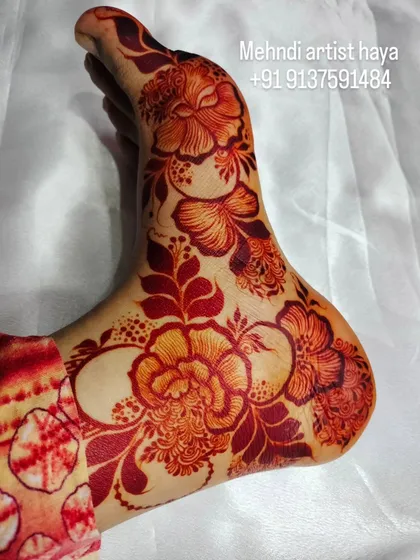 The beautiful orange-red stain of a fresh henna application. This is the first stage of the color, which will darken over the next 48 hours into a deep brown.