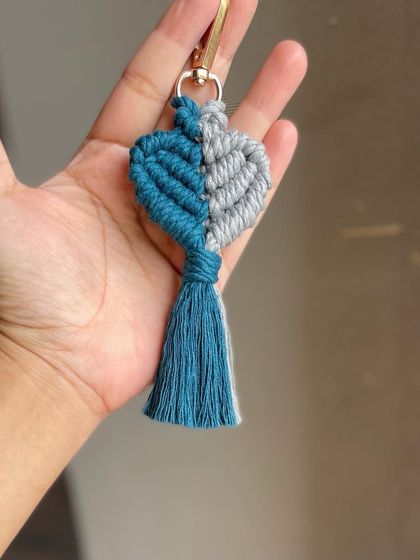 Holding the double-shaded heart keychain to show its size.