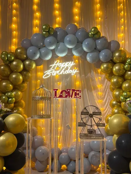 Another angle of the grey and gold birthday decor, showing the "LOVE" sign and glowing fairy lights. Every detail is set up to look great in photos.