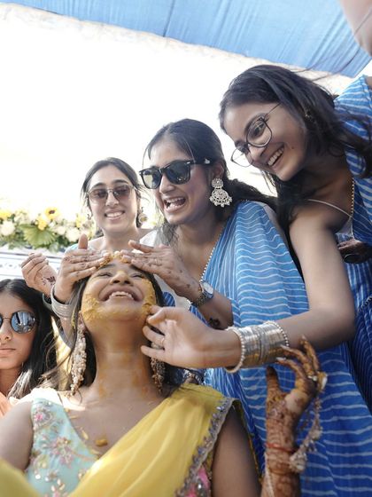 Friends and family are what make a wedding special. Here, my friends are styled in coordinated blue and white leheriya sarees, creating a beautiful contrast against the yellow theme of the Haldi.
