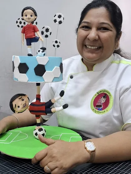 Here I am with the two parts of the football anti-gravity cake, created during our masterclass. This shows how we build these complex cakes in manageable parts for easy assembly.
