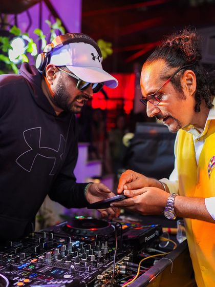 Discussing the next track with a guest. I love making the party interactive and fun for everyone.