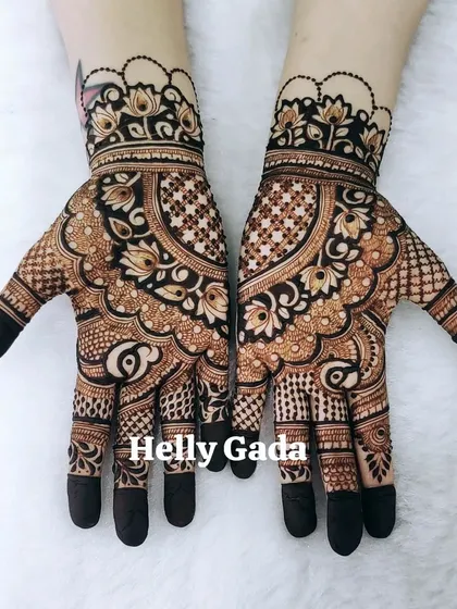 A beautiful design for siders, featuring a central peacock and lotus motif. The fingers are tipped, and the pattern is dense but doesn't cover the entire hand.