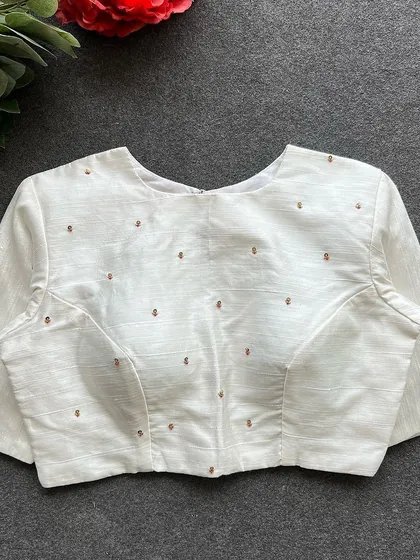 Another view of the front of the white Elzara silk blouse.