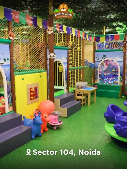Here is a wide view of our jungle-themed indoor playground. I wanted to create a vibrant, clean, and safe space packed with different activities, from the foam pit to the trampoline and merry-go-round.