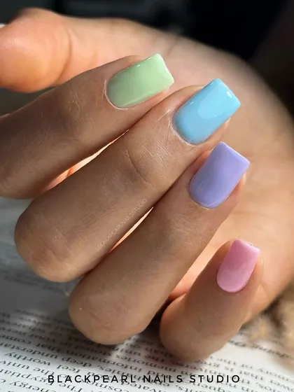 A fun and uplifting "candy crush" manicure featuring a different pastel shade on each finger. This look is perfect for lifting your mood and embracing a playful, colorful vibe.