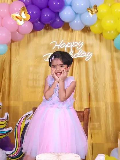 A sweet and playful pose from the birthday girl at her unicorn-themed party. Her expression of excitement is priceless.